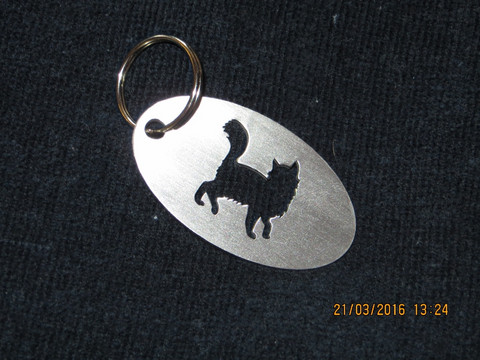 Keychain oval cat is coquettish