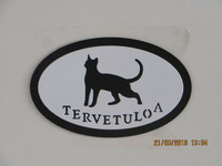 Welcome signboard cat stands short-haired