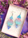 Unelmaiset Ruffle Armyn Gradient Triangle -korvakorut