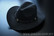 black cowboy hat (with leather band, could be different than in the pic)