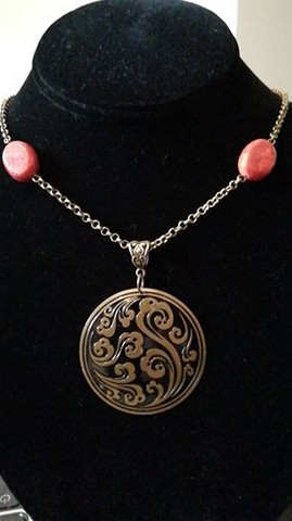 Patterned necklace with red stones