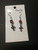 Cross earrings with a red bead