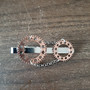Copper-colored steampunk tie clip with chain