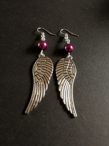 Silver colored wing earrings violet bead