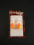 Orange lollipop earrings with dots