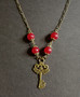 Key necklace with red beads