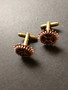 copper-colored gear cuff-links