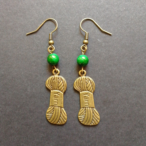 Yarn earrings with green shell beads