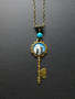Key necklace with castle and blue bead