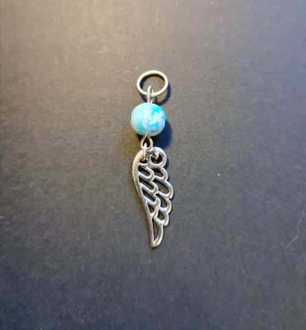 Wing place marker with a blue bead