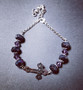 Cross bracelet with black and violet beads