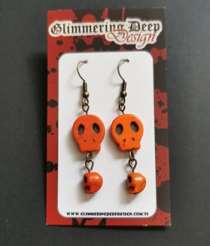 Orange golored skull earrings
