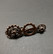 Steampunk tie clip with copper-colored gears.