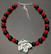 Spotted rose with black and red beads.