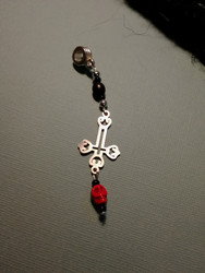 Lock charm inverted cross and a red skull