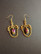 Hanging gold coloring earrings with purple drop