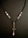 Cross necklace with black chain and violet beads