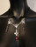 Silver colour crosses necklace with red drops