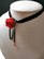 Necklace with a rose and black chains