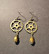 Gear earrings with gold colored drop