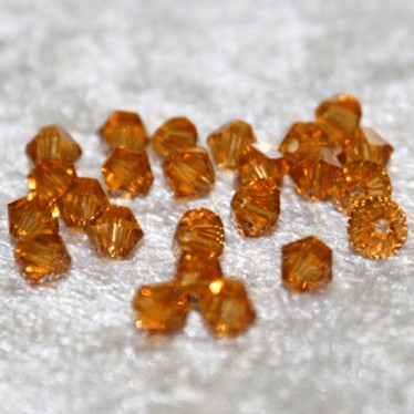 Swarovski 4 mm bicone topaasi
