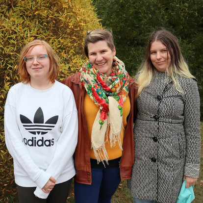 Väylän työntekijät Sara, Heidi ja Veera seisovat rinnakkain hymyillen.