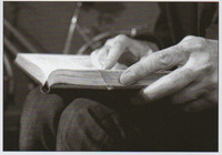 Old hands holding a book
